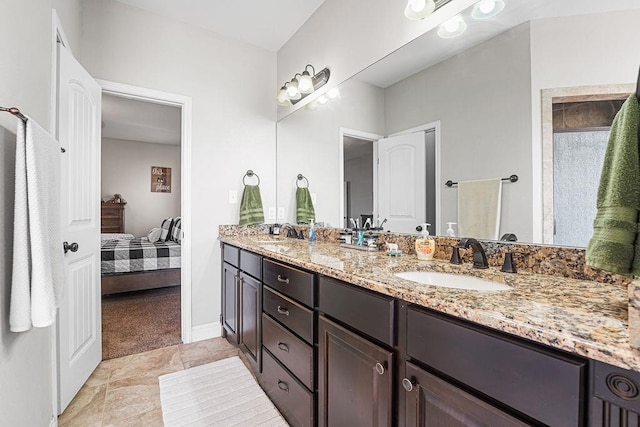 ensuite bathroom with double vanity, a sink, and ensuite bath