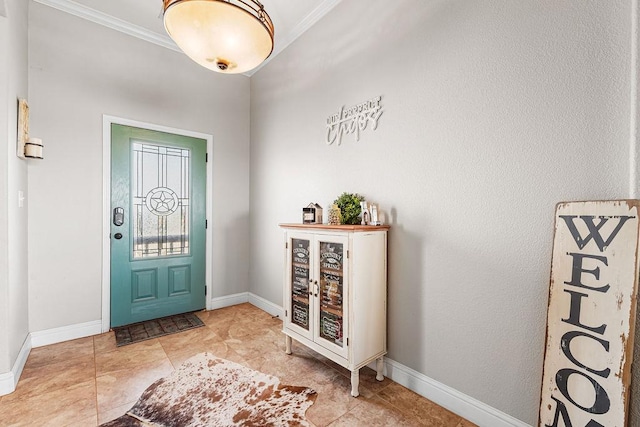 entryway featuring baseboards, ornamental molding, and a bar