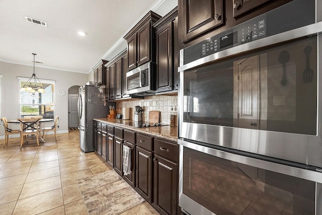 kitchen featuring visible vents, ornamental molding, decorative backsplash, light tile patterned flooring, and stainless steel appliances