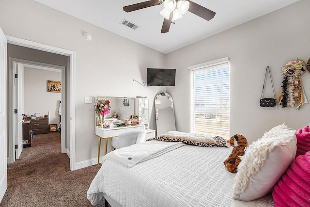 carpeted bedroom featuring visible vents, a ceiling fan, and baseboards