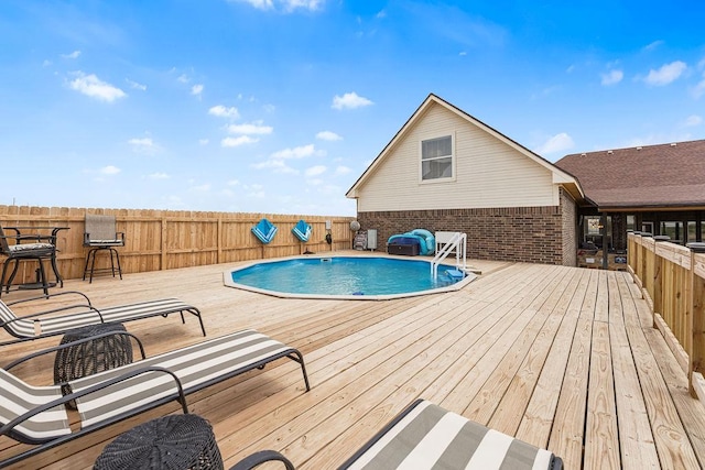 view of pool featuring a fenced in pool, a wooden deck, and fence