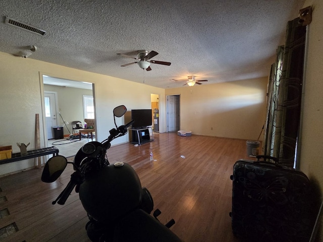 3301 N Jackson Ave, Odessa, TX 79762 - workout area with light wood-type flooring, a textured ceiling, and ceiling fan