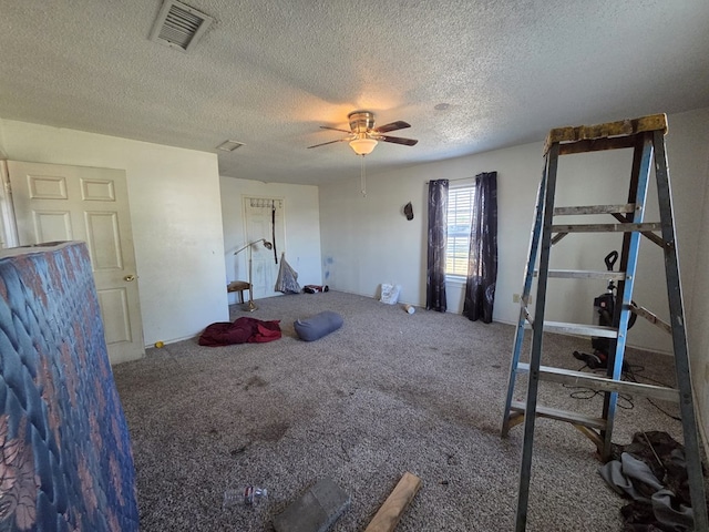3301 N Jackson Ave, Odessa, TX 79762 - exercise room with a textured ceiling, a ceiling fan, and carpet flooring