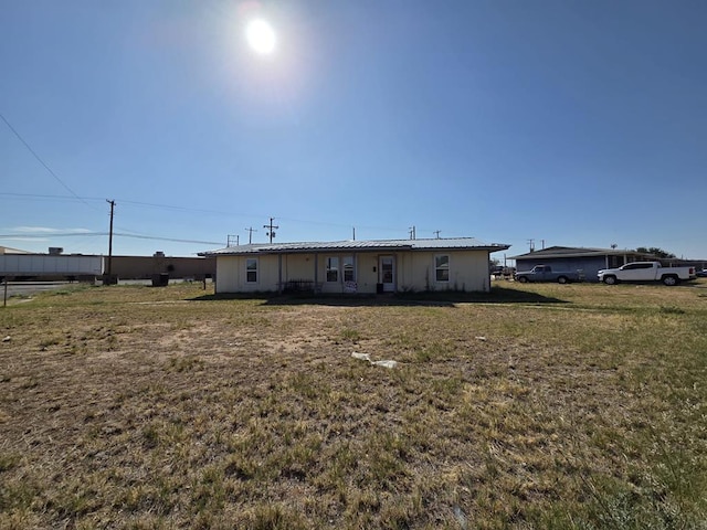3301 N Jackson Ave, Odessa, TX 79762 - rear view of property with a lawn and metal roof