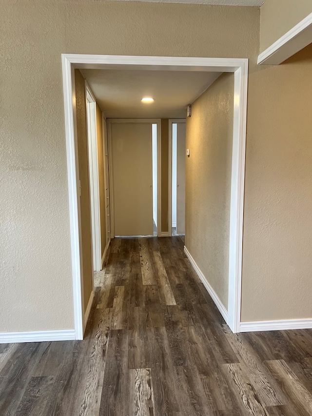 1100 NW 7th St, Andrews, TX 79714 - corridor featuring dark wood finished floors and a textured wall