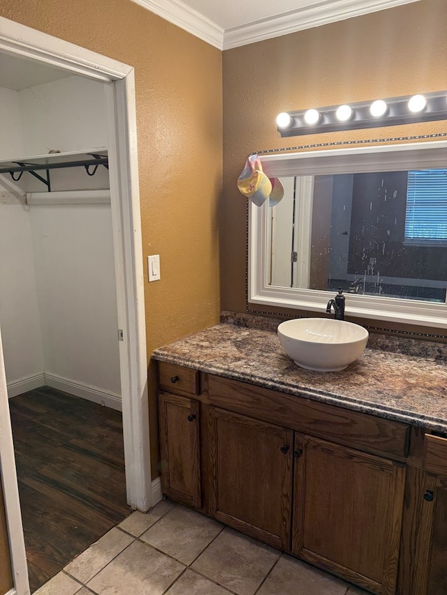 4235 Candy Ln, Odessa, TX 79762 - bathroom with crown molding, vanity, a textured wall, and tile patterned flooring