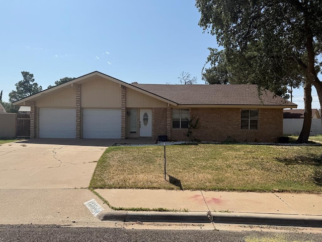 4235 Candy Ln, Odessa, TX 79762 - view of front of property with a garage, driveway, brick siding, a front yard, and roof with shingles