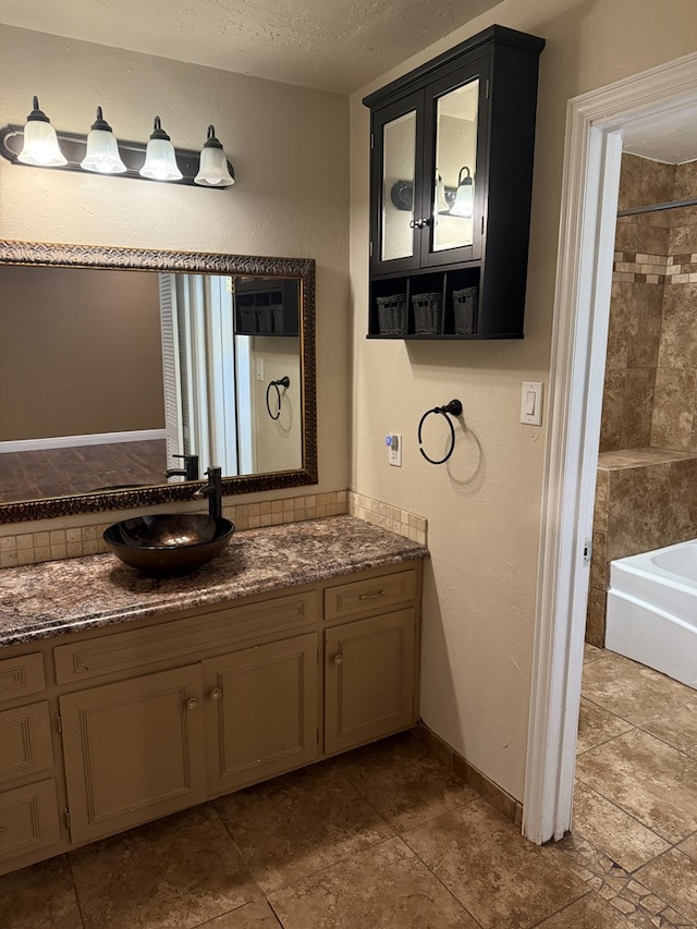 4235 Candy Ln, Odessa, TX 79762 - bathroom featuring vanity, a textured ceiling, and bathing tub / shower combination