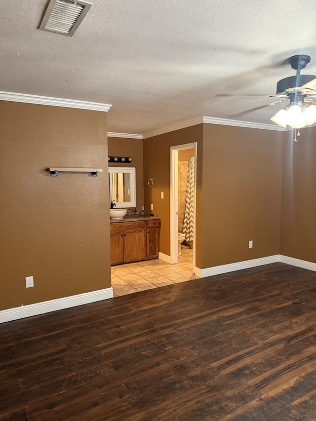 4235 Candy Ln, Odessa, TX 79762 - unfurnished room featuring light wood-style flooring, ornamental molding, a textured ceiling, and a ceiling fan