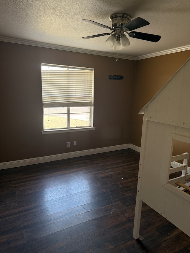 4235 Candy Ln, Odessa, TX 79762 - empty room with ceiling fan, a textured ceiling, crown molding, and dark wood-type flooring