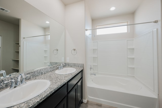 full bathroom featuring  shower combination, visible vents, a sink, and double vanity