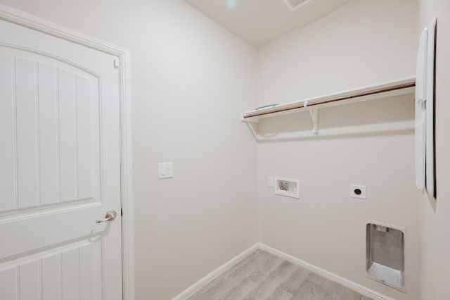 laundry room featuring baseboards, light wood finished floors, washer hookup, laundry area, and electric dryer hookup