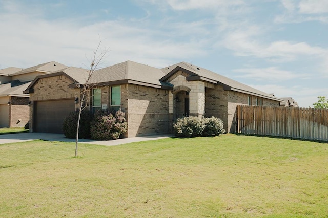 view of front facade with fence, a garage, a front lawn, and brick siding