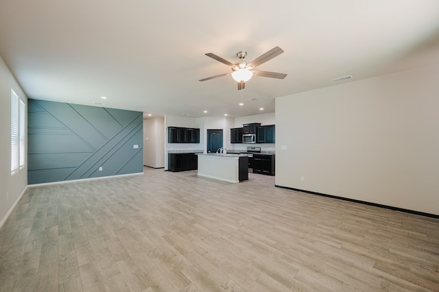 unfurnished living room with visible vents, recessed lighting, ceiling fan, baseboards, and light wood-style floors