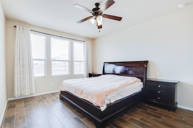 bedroom featuring dark wood-style flooring, baseboards, and a ceiling fan