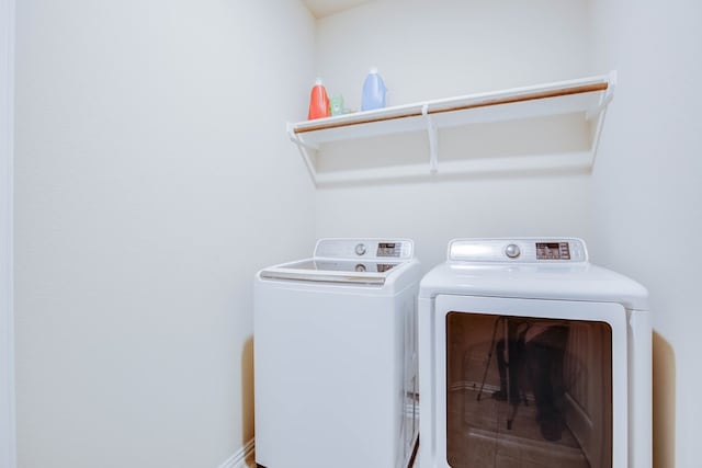 washroom featuring laundry area and washer and clothes dryer