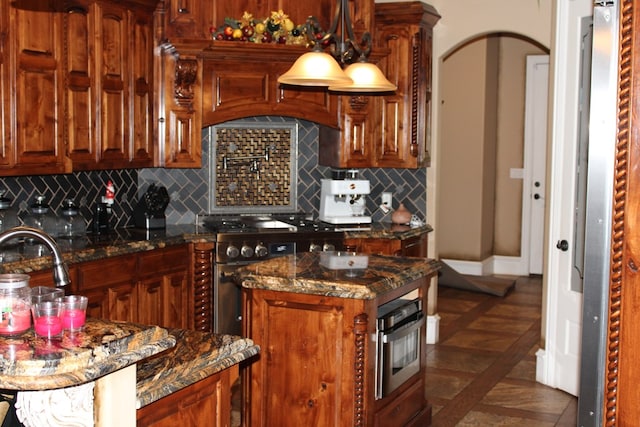 173 W 87th St, Odessa, TX 79764 - kitchen with tasteful backsplash, stainless steel appliances, and dark stone counters