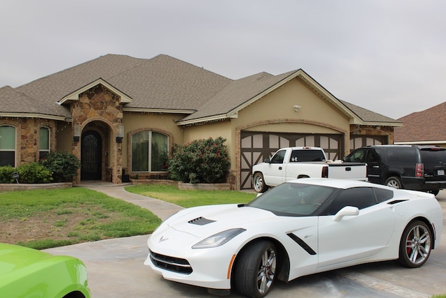 173 W 87th St, Odessa, TX 79764 - french country home featuring stone siding, an attached garage, roof with shingles, a front lawn, and stucco siding