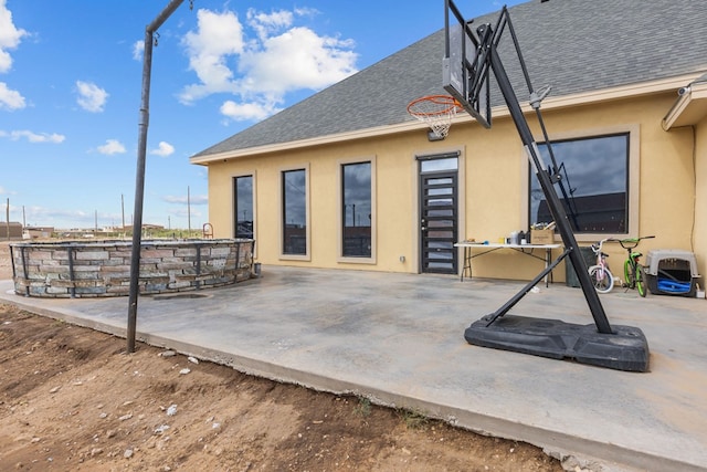 1758 N Fortune 500 Dr, Odessa, TX 79764 - back of property with a patio area, stucco siding, and a shingled roof