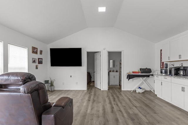 1758 N Fortune 500 Dr, Odessa, TX 79764 - living area featuring light wood-type flooring, vaulted ceiling, and baseboards