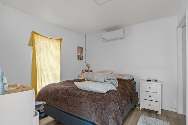 1758 N Fortune 500 Dr, Odessa, TX 79764 - bedroom with a wall mounted air conditioner and wood finished floors
