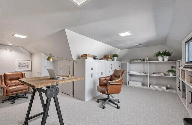 office with visible vents, lofted ceiling, and carpet