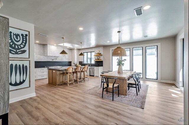 dining room with recessed lighting, light wood-style floors, and visible vents