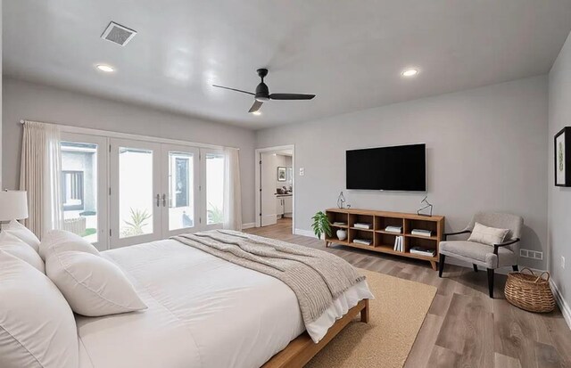 bedroom featuring visible vents, light wood-style flooring, recessed lighting, access to exterior, and french doors