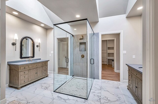 bathroom featuring marble finish floor, a stall shower, and vanity