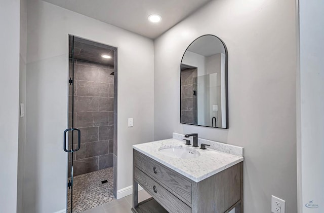 bathroom featuring vanity, baseboards, recessed lighting, a shower stall, and tile patterned floors