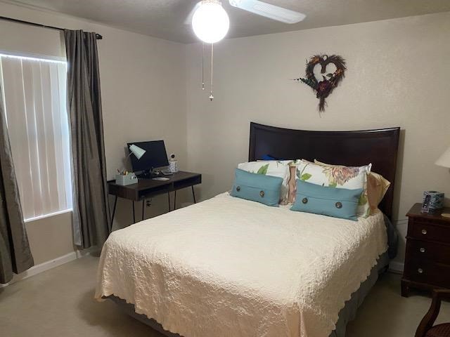 1413 S Oak St, Pecos, TX 79772 - bedroom featuring baseboards, a ceiling fan, and light colored carpet