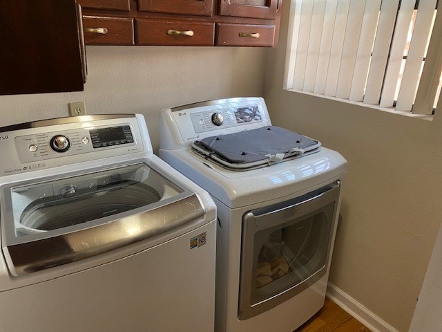 1413 S Oak St, Pecos, TX 79772 - washroom featuring wood finished floors, cabinet space, and washer and clothes dryer