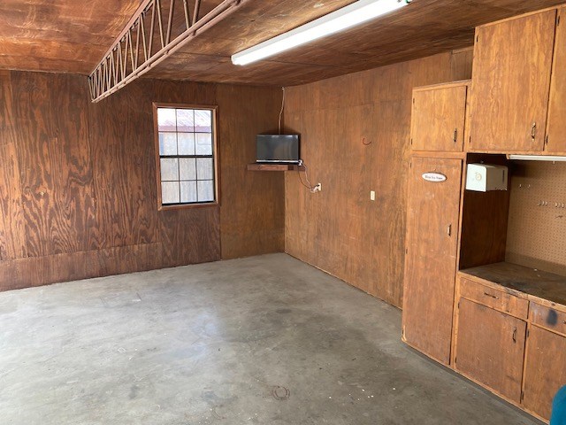 1413 S Oak St, Pecos, TX 79772 - garage with wood walls