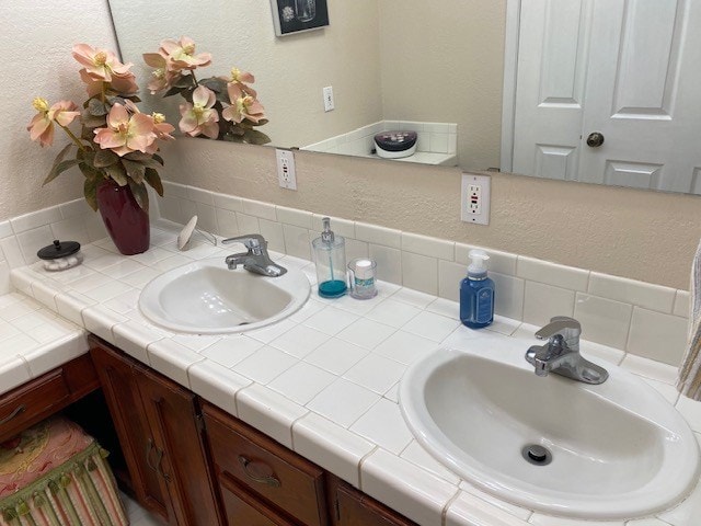 1413 S Oak St, Pecos, TX 79772 - bathroom with double vanity, a textured wall, and a sink