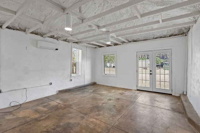 201 S Front St, Fort Davis, TX 79734 - spare room with a wall mounted air conditioner, french doors, and unfinished concrete floors
