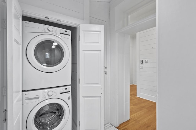 201 S Front St, Fort Davis, TX 79734 - washroom with stacked washing machine and dryer and light wood-type flooring