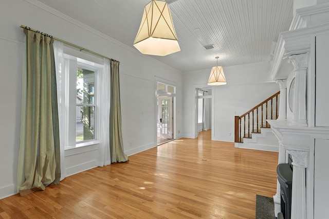 201 S Front St, Fort Davis, TX 79734 - entrance foyer with plenty of natural light, light wood finished floors, stairs, crown molding, and a wood stove