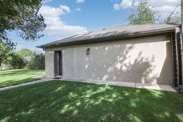 201 S Front St, Fort Davis, TX 79734 - rear view of property with a lawn, stucco siding, and roof with shingles