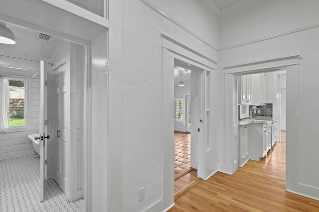 201 S Front St, Fort Davis, TX 79734 - corridor featuring a sink and light wood-style flooring