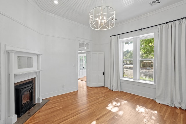 201 S Front St, Fort Davis, TX 79734 - unfurnished living room with light wood finished floors, crown molding, a chandelier, and a fireplace