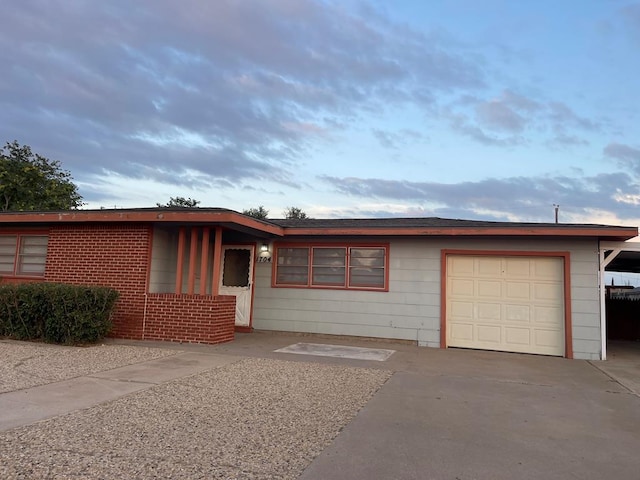 1704 E 12th St, Odessa, TX 79761 - single story home with an attached garage, brick siding, and concrete driveway