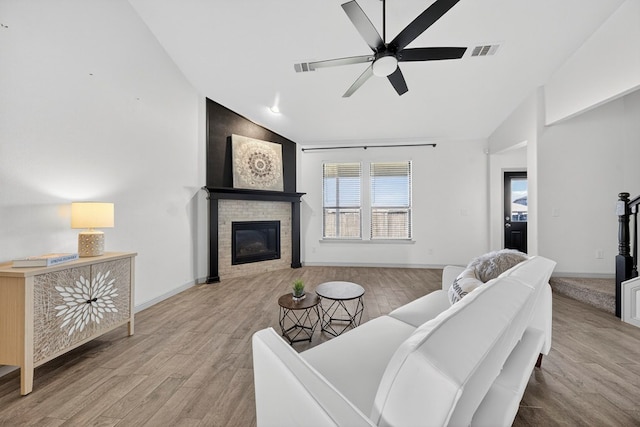 7410 W Pile Ranch Rd, Odessa, TX 79765 - living area featuring lofted ceiling, ceiling fan, wood finished floors, and a fireplace