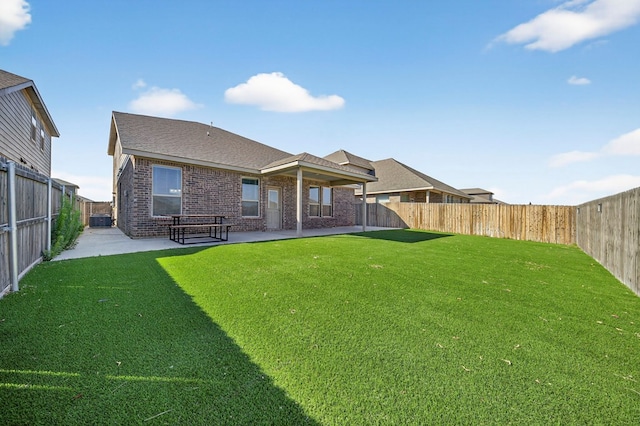 7410 W Pile Ranch Rd, Odessa, TX 79765 - back of property with a patio area, brick siding, a fenced backyard, and a shingled roof