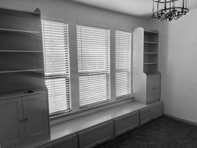 7410 W Pile Ranch Rd, Odessa, TX 79765 - mudroom featuring dark carpet and a chandelier