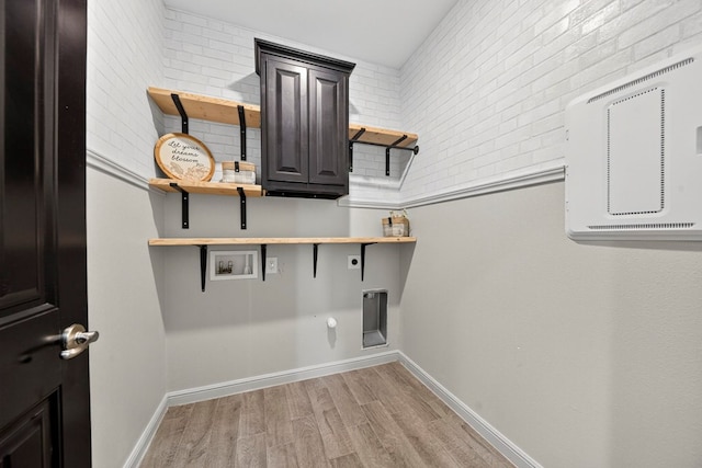 7410 W Pile Ranch Rd, Odessa, TX 79765 - laundry room with hookup for an electric dryer, light wood finished floors, hookup for a washing machine, cabinet space, and gas dryer hookup