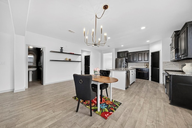 7410 W Pile Ranch Rd, Odessa, TX 79765 - dining space with light wood-type flooring, a chandelier, and recessed lighting