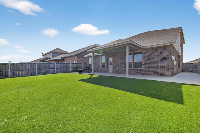 7410 W Pile Ranch Rd, Odessa, TX 79765 - rear view of house featuring a patio area, brick siding, a fenced backyard, and a shingled roof