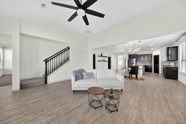 7410 W Pile Ranch Rd, Odessa, TX 79765 - living area with a chandelier, light wood-type flooring, stairway, a ceiling fan, and recessed lighting