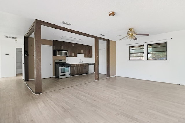 3633 Melody Ln, Odessa, TX 79762 - kitchen with stainless steel appliances, a ceiling fan, dark brown cabinets, light wood-type flooring, and light countertops