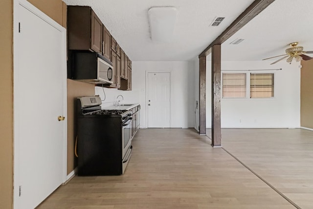 3633 Melody Ln, Odessa, TX 79762 - kitchen with appliances with stainless steel finishes, a ceiling fan, and light wood finished floors